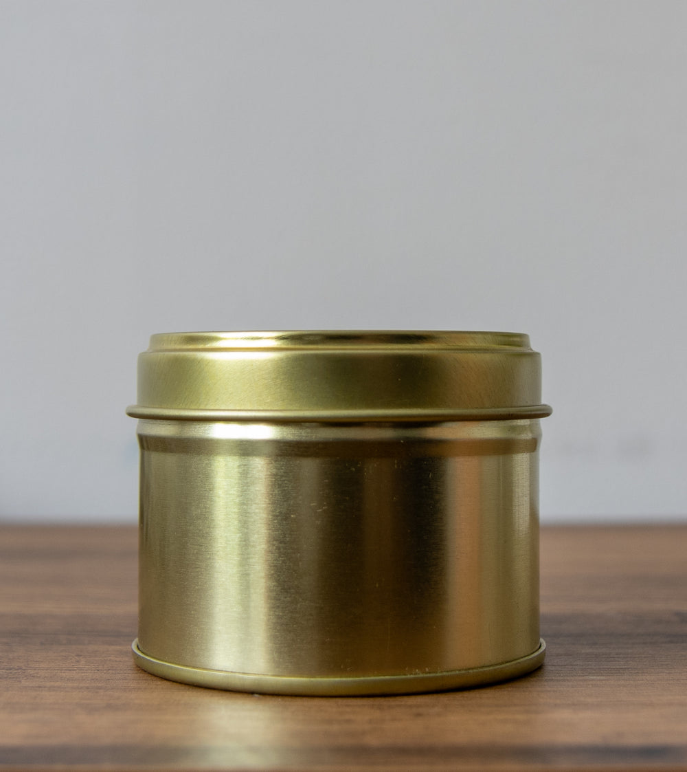 100g white label candle tin in gold