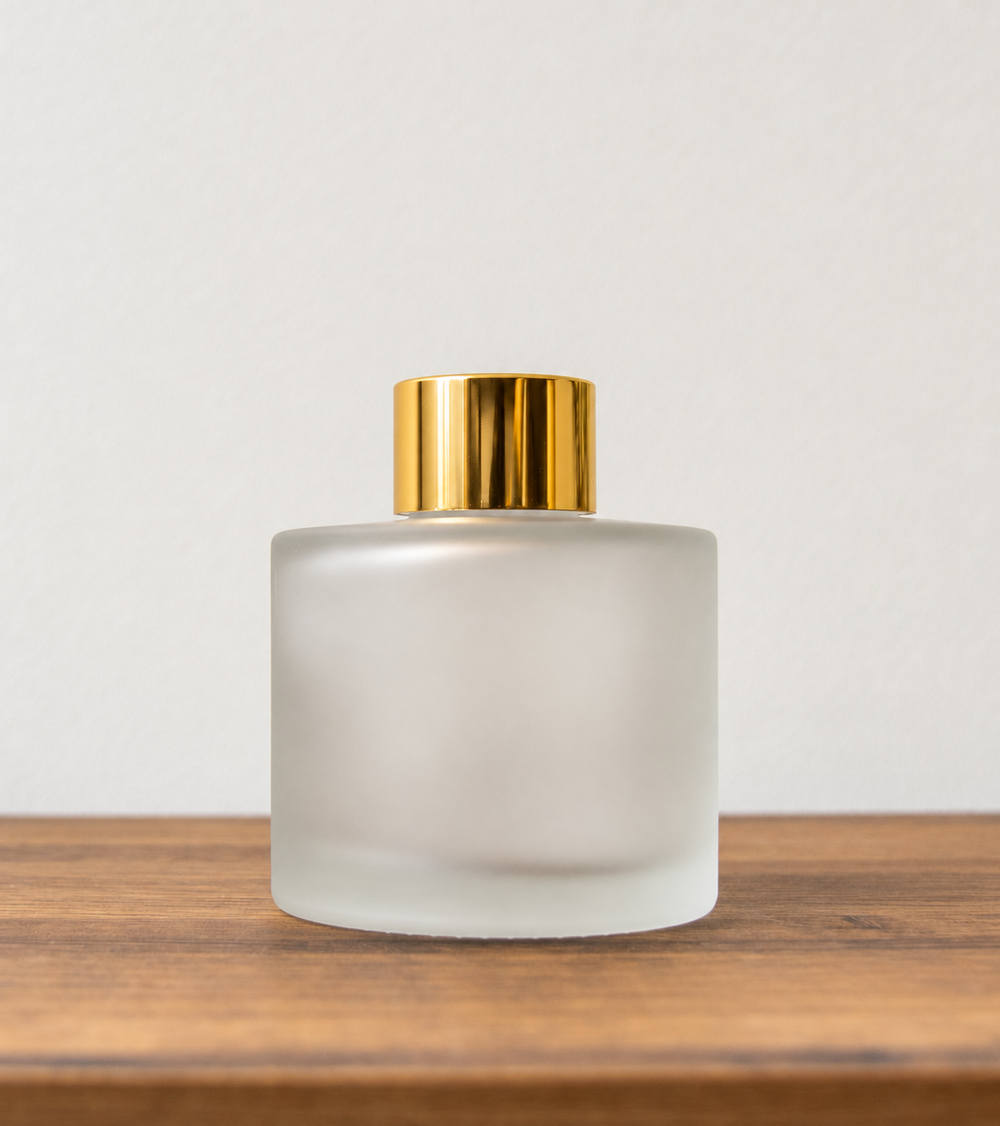 Reed diffuser bottle with gold cap in Frosted Glass