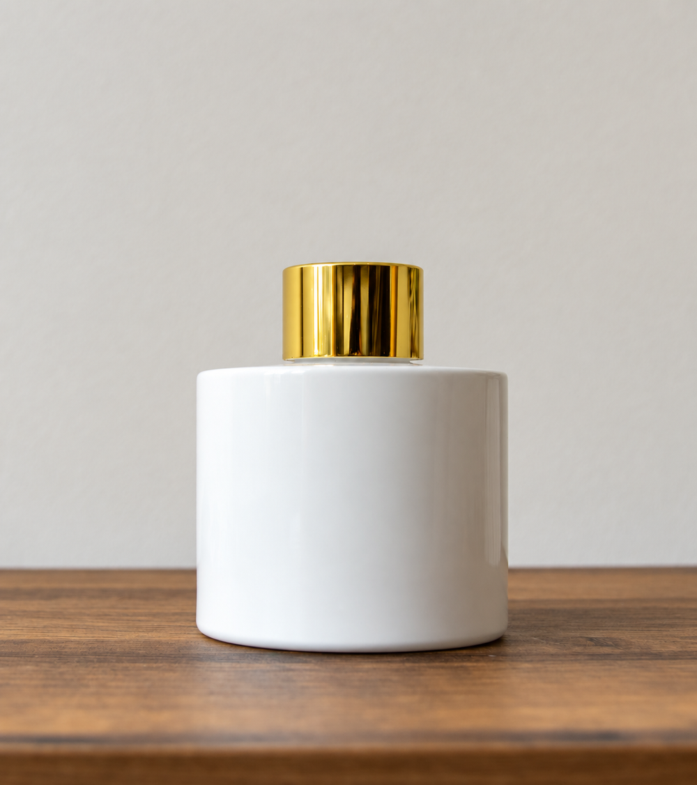 Reed diffuser bottle with gold cap in White Gloss