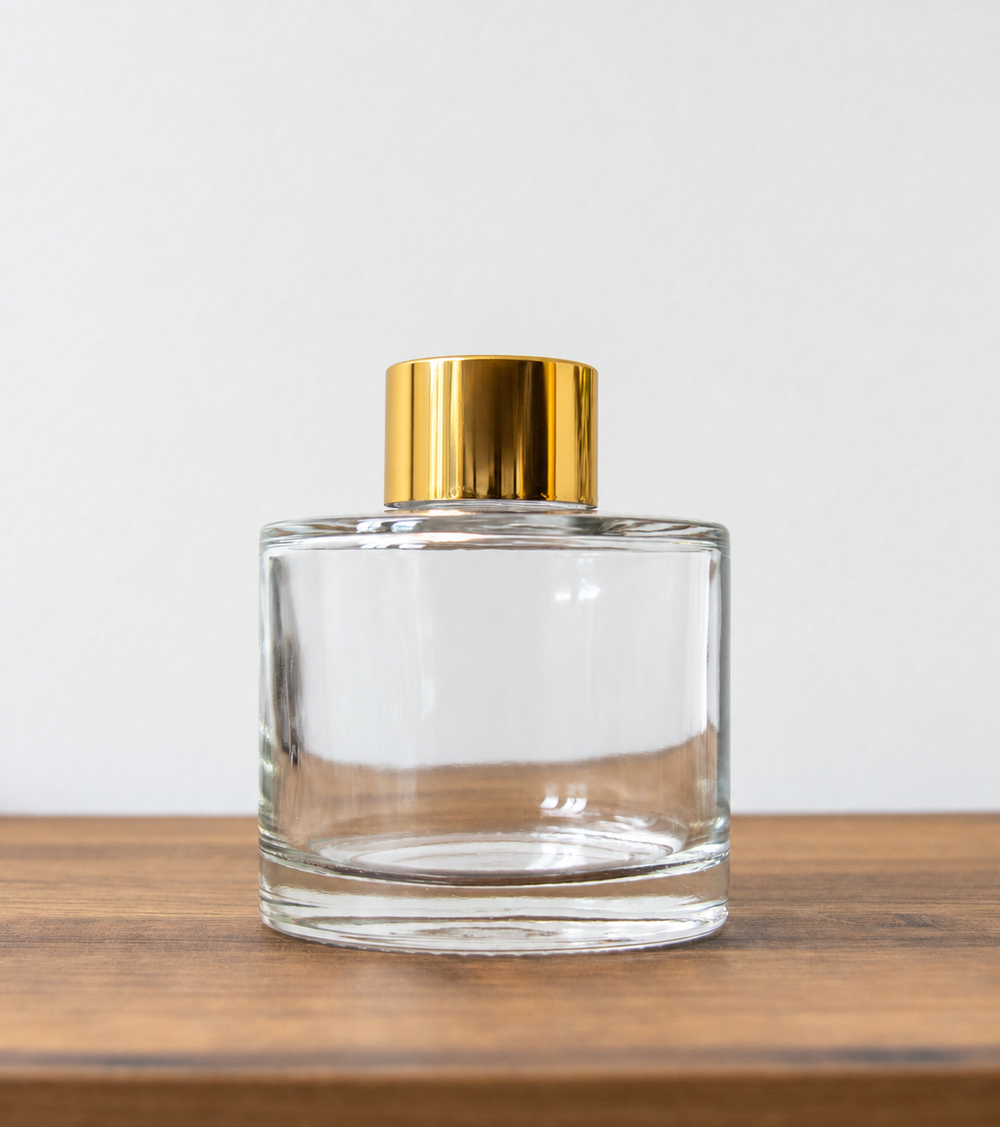 Reed diffuser bottle with gold cap in clear
