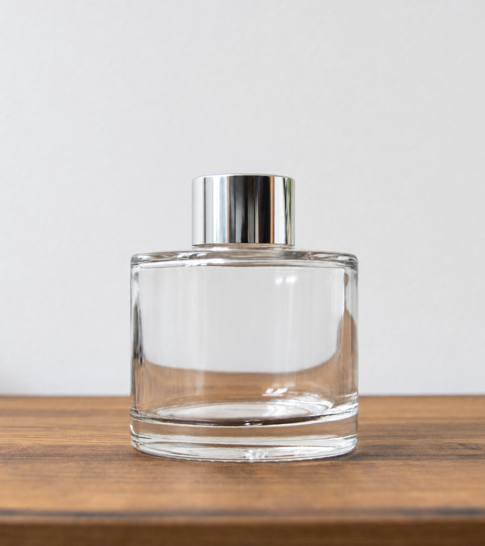 Reed diffuser bottle with silver cap in clear